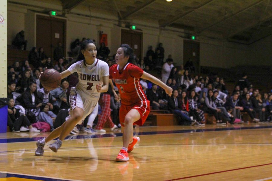 Senior guard KD Lee drives to the basket trying to avoid an Eagle defender.