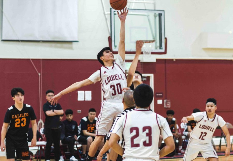 Sophomore forward Jeremiah Hizon jumps up and gets the ball in the tip off against the Galileo Lions at home on Jan. 31. 