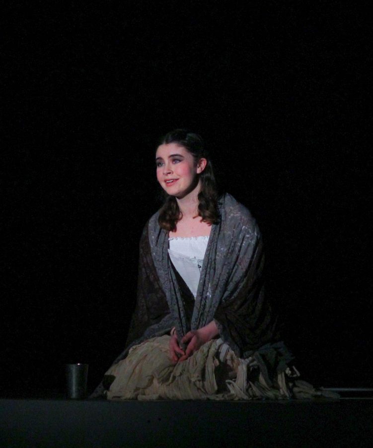 Junior Emma Greene opens the show as the Beggar Woman.