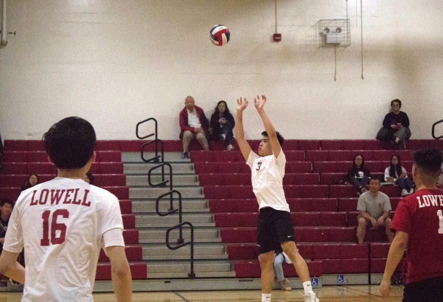 As his teammates attentively watch, junior right side hitter George Pan leaps for a hit against the Washington Eagles on April 10  at home.