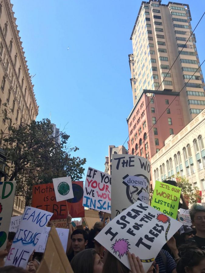 Students gathered around the San Francisco Federal Building with their signs at the start of the march.