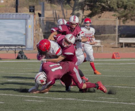 Lowell defense tackles the opponent. Photo by Nico Ramirez.