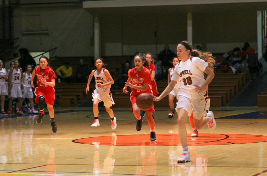 Freshman point guard Elle Ladine dribbles the ball down the court. 