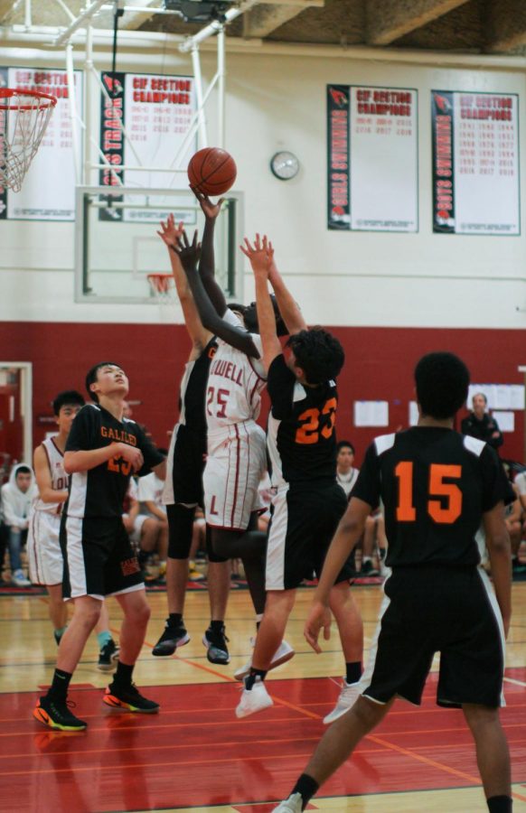 Sophomore forward Kevin Silvestro lays up the ball in midst of two Lion defenders attempting to block him.