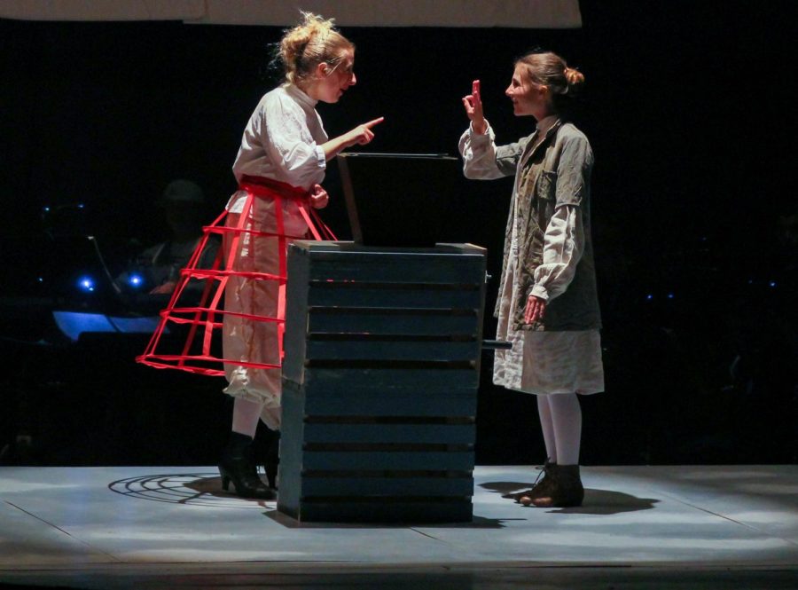 Senior Samantha Rich, as Mrs. Lovett, teaches junior Isabelle Trillin-Lee, playing Tobias Ragg, how to grind meat.