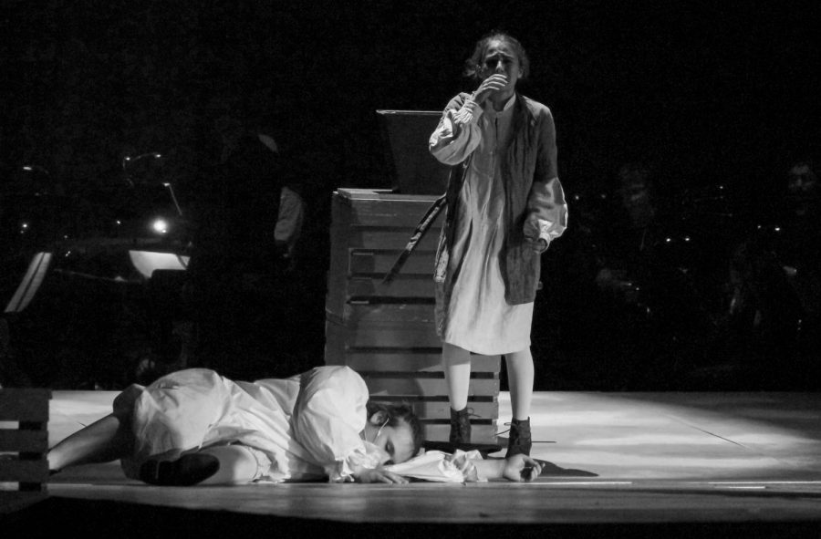 Junior Isabelle Trillin-Lee, as Tobias Ragg, sobs as he stands next to the corpse of senior Andrew Green, playing the Beadle.