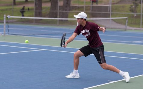 Senior Andrew Trinh, who won his doubles matches against the Archbishop Riordan Crusaders on April 5 at home, performs a backhand shot.