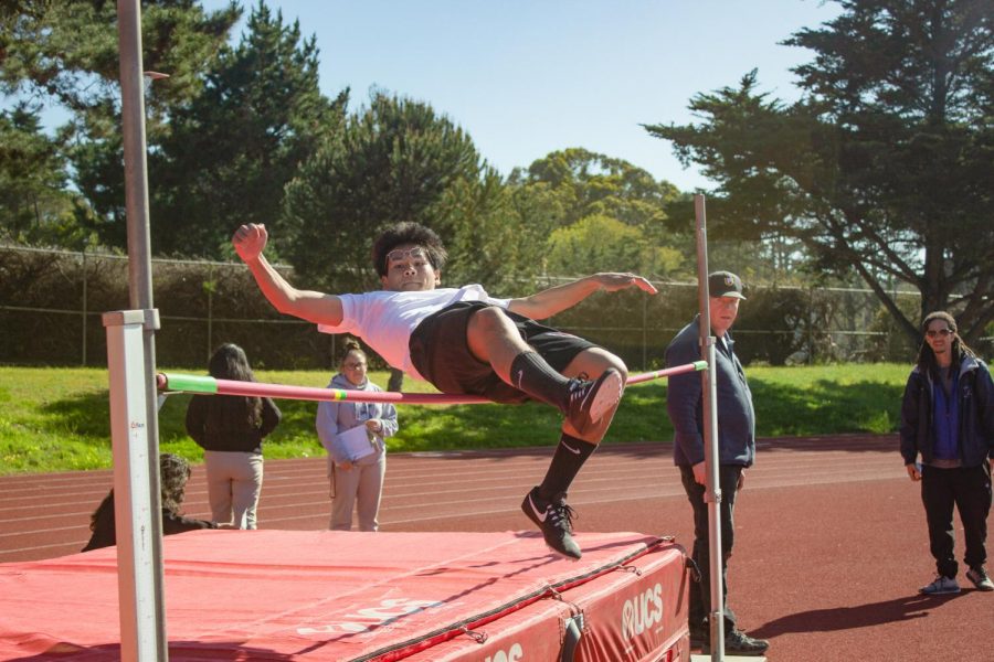 Freshman Andy Truong jumps over the bar in the high jump.