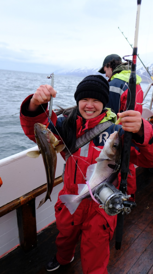 Hong shows off the fish she caught in Iceland.