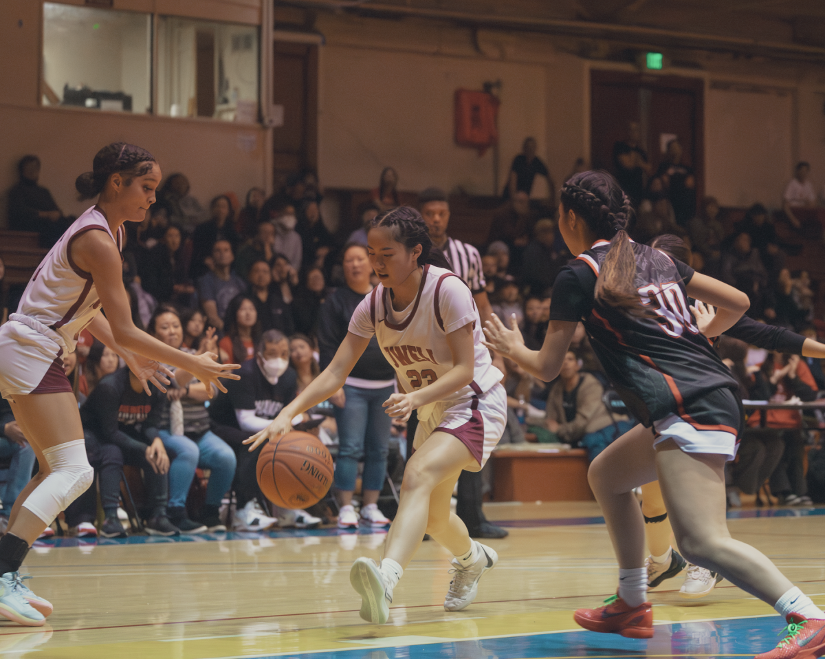 Sophomore Jasmine Lee (23) dribbles the ball to the basket.